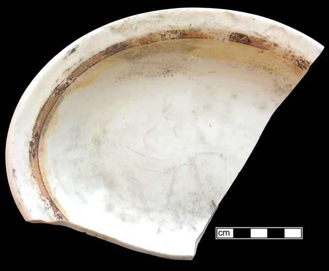 Refined white earthenware oval platter with floral decals along the rim and in the center of the vessel.  The platter also has rococo molding along the rim.  Note the post-depositional iron staining in the center of the vessel. 